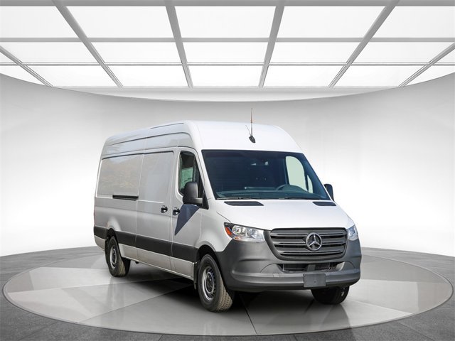 Mercedes-Benz Sprinter cargo van shell in a bright showroom, ready for custom conversion.